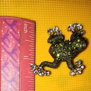 Green rhinestone from with crystal toes accents brooch